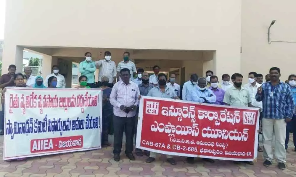 LIC employees staging lunch hour demonstration in support of the farmers agitating for the repeal of anti-farmer enactments in Vijayawada on Monday