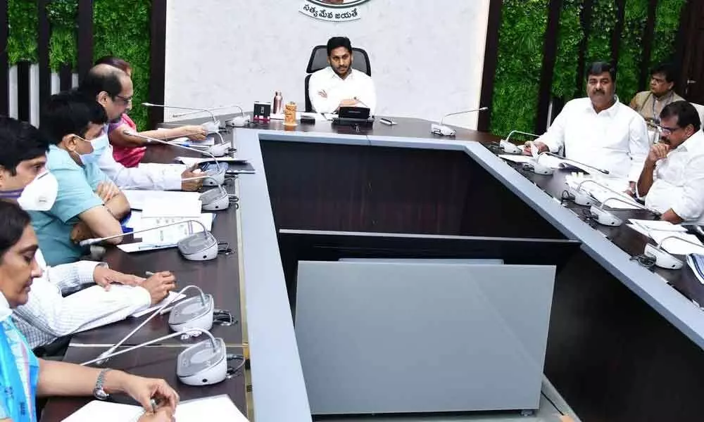Chief Minister Y S Jagan Mohan Reddy reviewing preparations for distribution of house site pattas with Housing Department officials and Ministers at Tadepalli on Monday