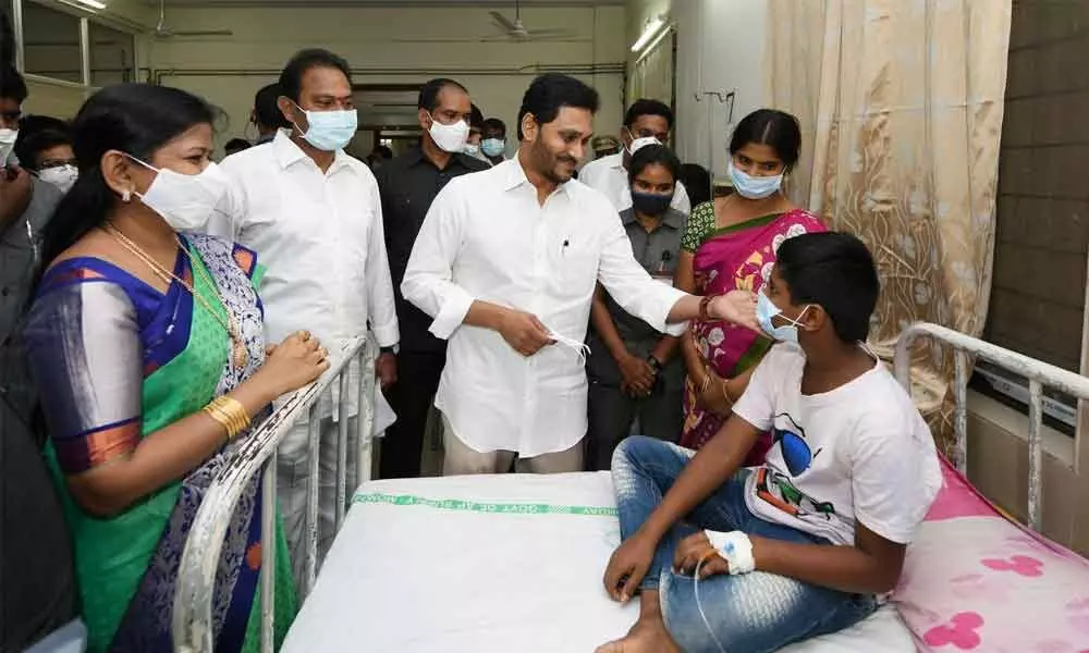 CM Jagan Mohan Reddy meets patients who fell ill, suspectedly due to water contamination, at a hospital in Eluru on Monday