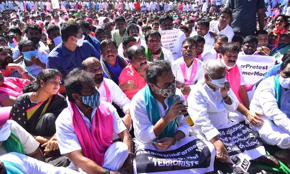 TRS working president K T Ramarao and other leaders staging a sit-in at the Burugula gate on NH 44 near Shadnagar in Rangareddy district on Tuesday	Photo: Adula Krishna