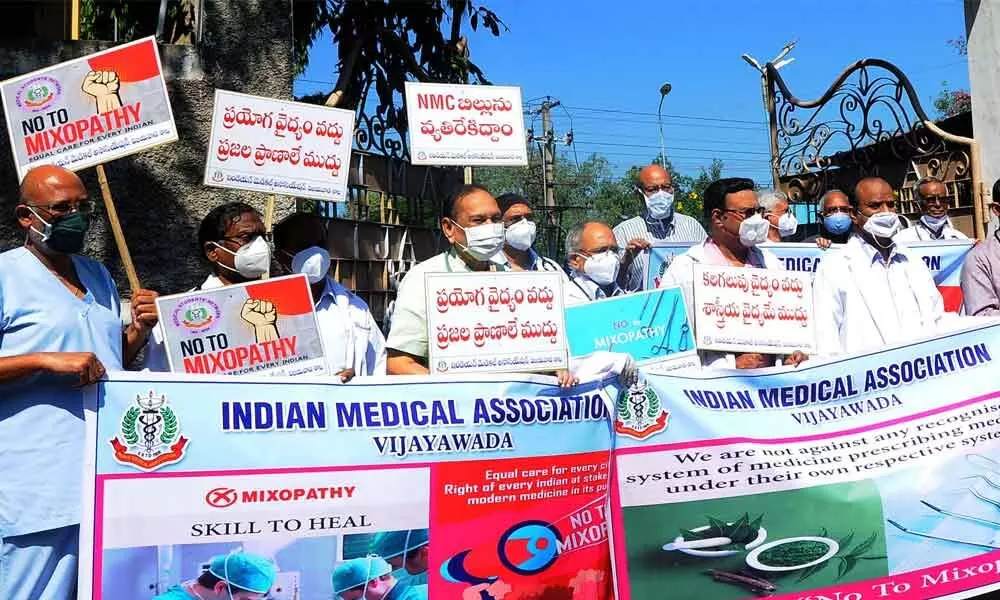 Indian Medical Association members staging a protest opposing NMC Bill in Vijayawada on Tuesday