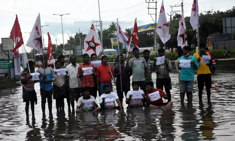 DYFI youth protests in stagnated rain water in Tirupati, demands to clear water on roads