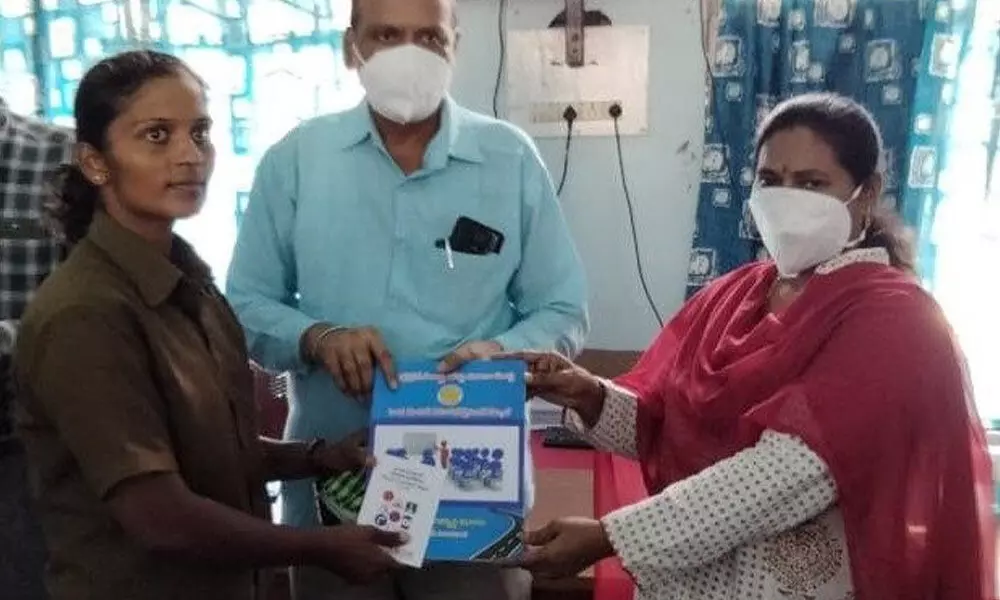 APSRTC Ongole regional manager G Vijaya Geetha presenting driving course material to woman candidate Reddi Rani in Ongole on Wednesday