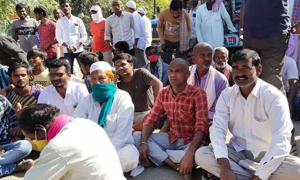 Villagers staging a sit-in dharna on the road on the outskirts of Khatgaon village on Wednesday