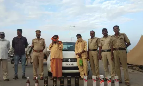 SEB personnel displaying seized NDPL liquor at Panchalingala checkpost on Wednesday