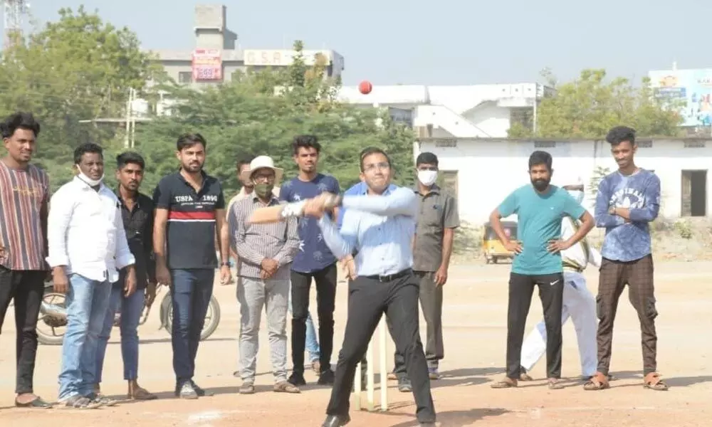 District Collector Musharraf Ali Farooqui playing cricket with youngsters at NTR Stadium in Nirmal on Thursday