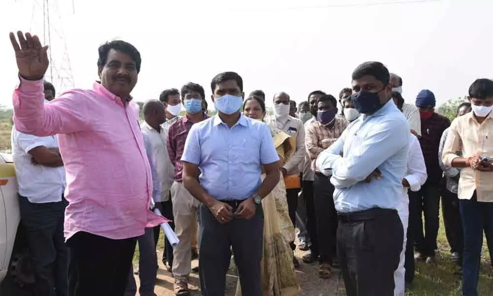 Srikalahasthi MLA B Madhusudhan Reddy and District Collector Dr N B Gupta inspecting the layout in Chindepalli where house sites were allotted to poor, on Monday