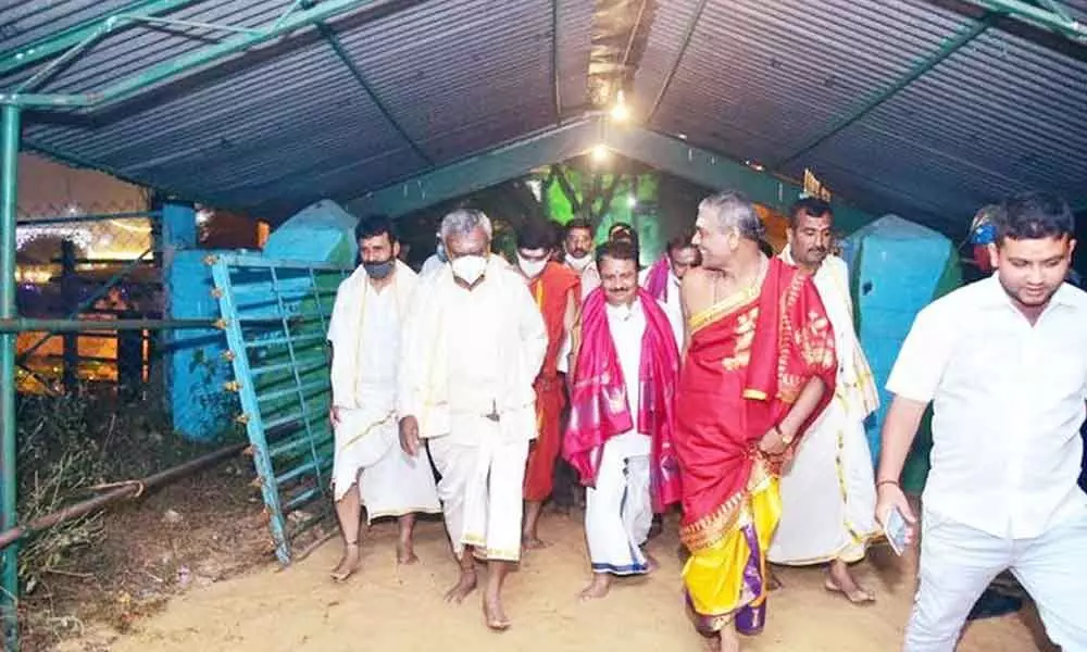 Mysuru District Minister S T Somashekar walking barefoot to reach Paathaleshwara and Maraleshwara temples in Talakadu