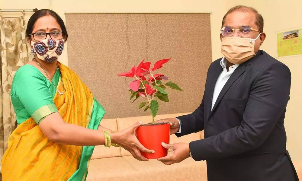 District Collector A Md Imtiaz presenting a bouquet to Pragna Parande, member of National Commission for Protection of Child Rights in Vijayawada on Tuesday