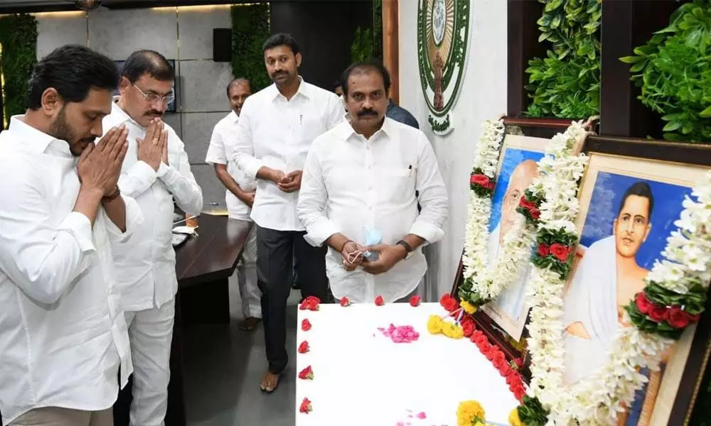 Chief Minister Y S Jagan Mohan Reddy pays tributes to Amarajeevi Potti Sreeramulu and Sardar Vallabhai Patel at his camp office on Tuesday