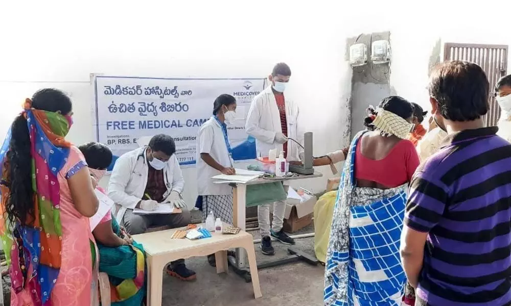 Doctors attending the patients at a medical camp organised by Medicover Hospital at Arepalli on Tuesday