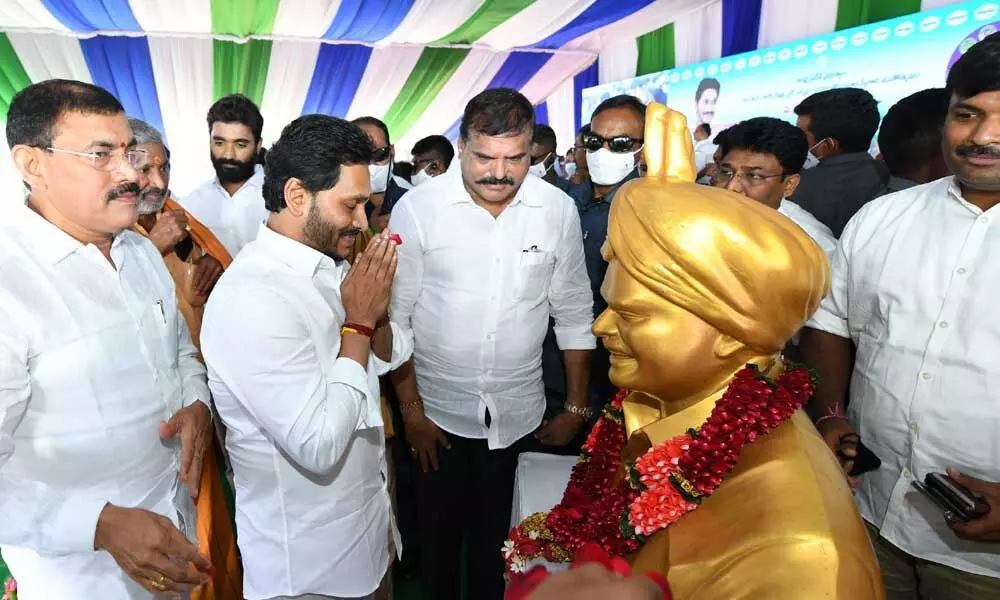 Chief Minister Y S Jagan Mohan Reddy pays tributes to his father and former Chief Minister Y S Rajasekhar Reddy at the BC Sankranti programme in Vijayawada on Thursday