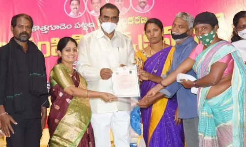 MLA Vanama Venakateswara Rao distributing pattas to the residents at a public meeting in Kothagudem on Thursday
