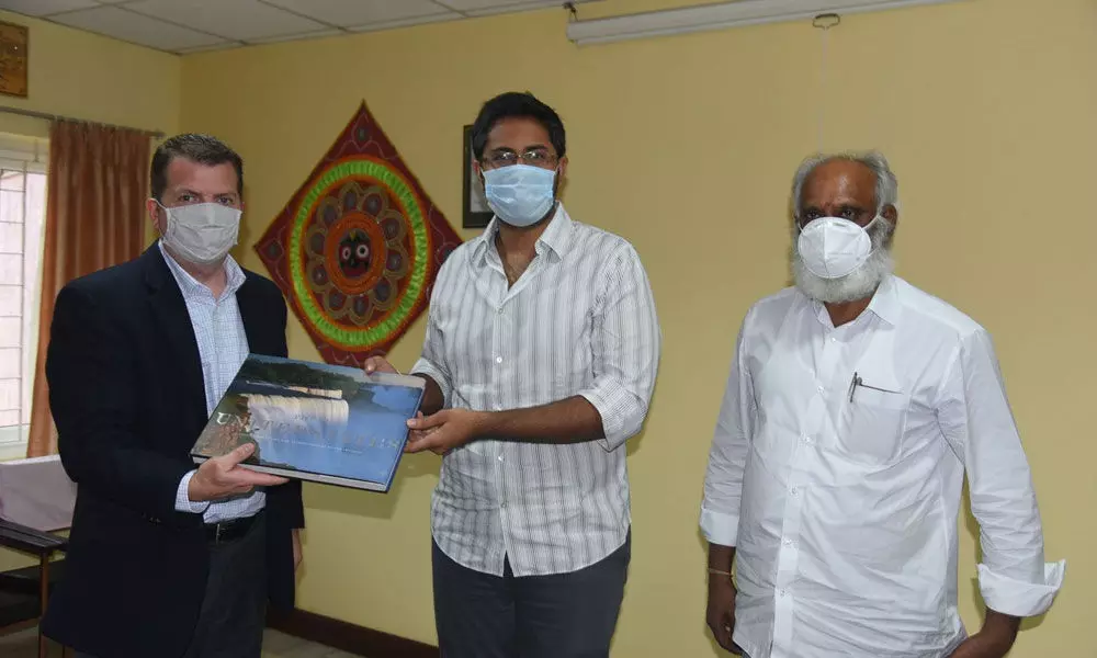 GITAM president M Sribharat and Vice-Chancellor K Sivaramakrishna presenting a Gandhian journal to the US Consulate official David Moyer in Visakhapatnam on Friday