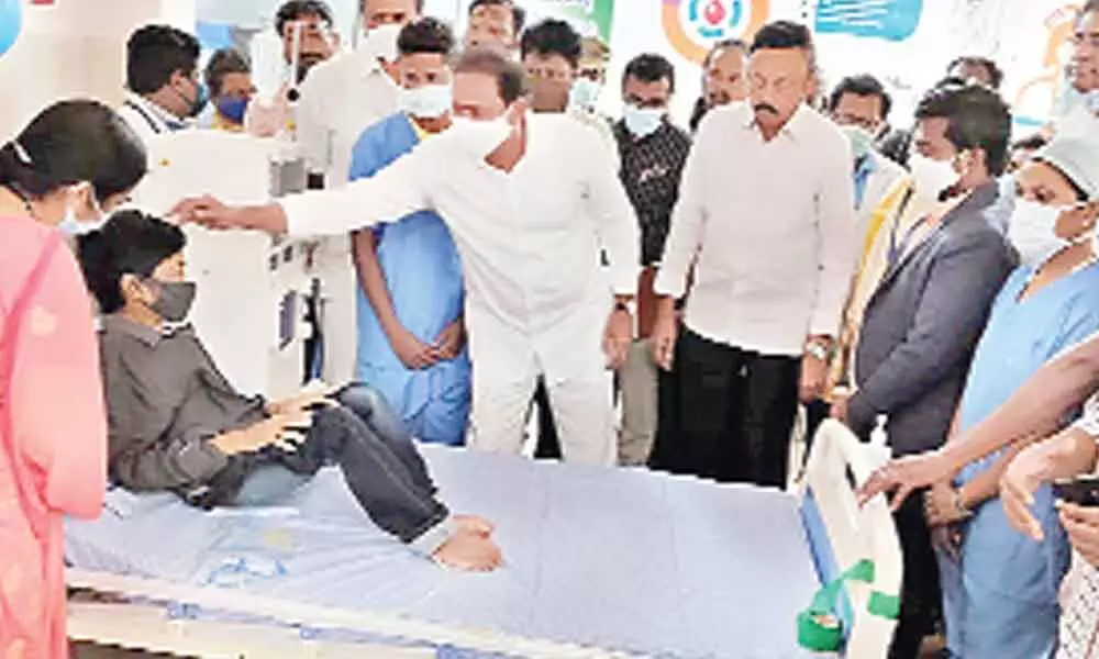 Health Minister Alla Kali Srinivas speaks to kidney patient after inauguration of the dialysis centre in Nuzvid