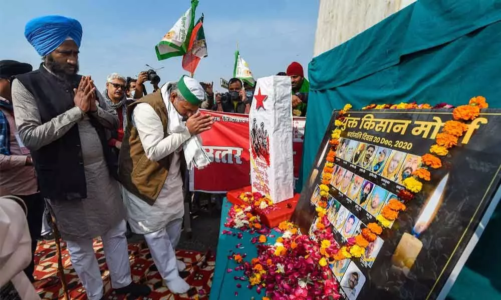 Bharatiya Kisan Union Spokesperson Rakesh Tikait pays tribute to farmers, who lost their lives amid their agitation, to observe Shaheed Diwas during a protest against farm reform laws at Delhi-UP border in Ghaziabad on Sunday