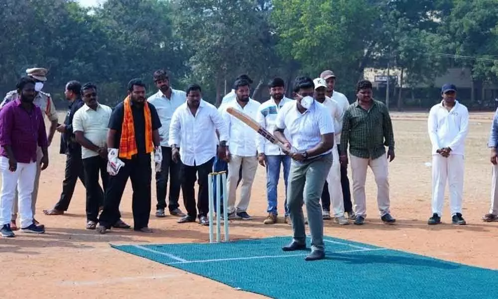 SP Bhaskaran ready to face the bowling by District Collector T Vinay Krishna Reddy after inaugurating inter-district cricket tournament in Suryapet on Sunday