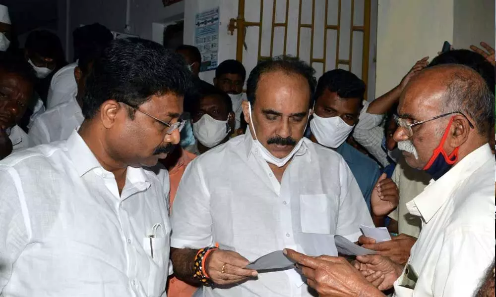 Virasam leader G Kalyana Rao and others submitting a memorandum to the ministers Balineni Srinivasa Reddy and Audimulapu Suresh demanding the lifting of cases under UAPA and other sections, in Ongole on Monday
