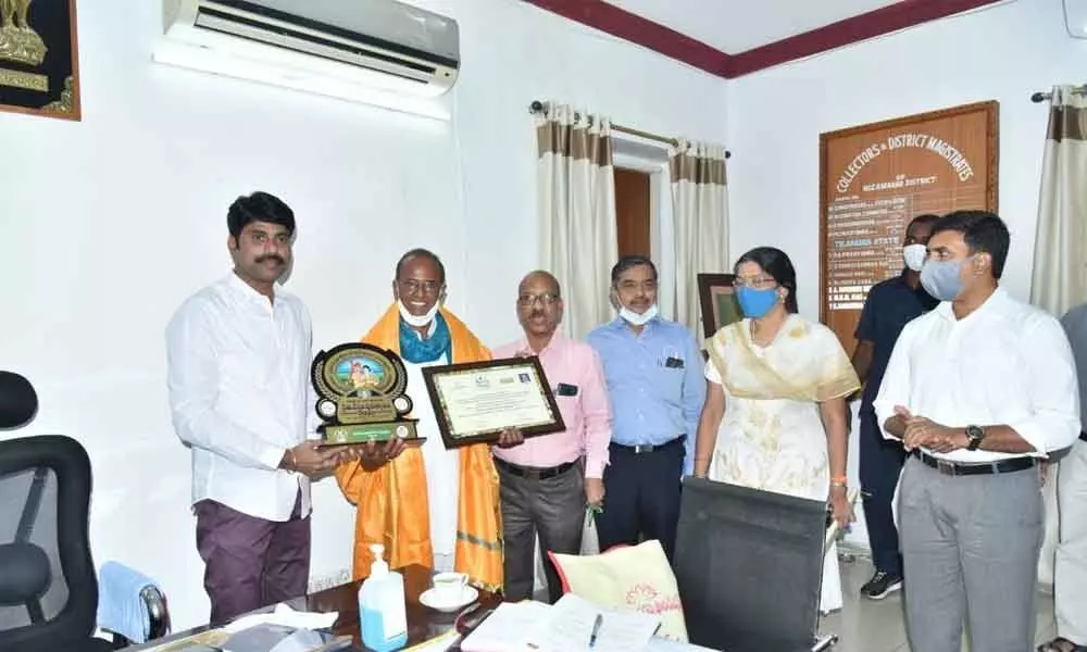 District Collector C Narayana Reddy along with Chinni Krishna, recipient of Rythu Nestam Award, at his chamber in Nizamabad on Monday