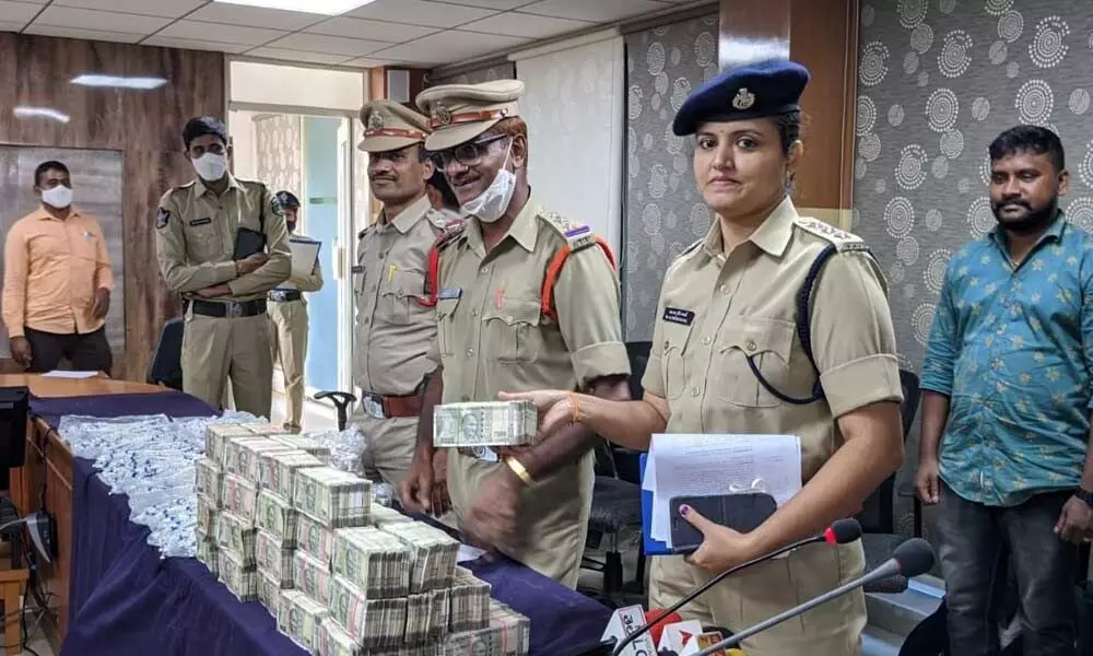 Task Force ACP Prem Kajal displaying the cash seized at a press conference in Visakhapatnam on Monday