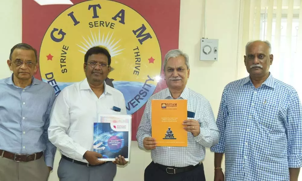 GITAM Registrar  D Gunasekharan and MGCHRI Managing Director V Muralikrishna exchanging the MoU documents in the presence of Vice-Chancellor  K Sivaramakrishna at GITAM campus in Visakhapatnam on Monday