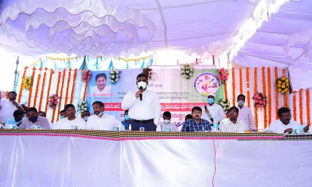 District Collector G Veera Pandiyan addressing the gathering after launching resurvey of lands at Pandipadu village in Kallur mandal of Panyam constituency on Tuesday. MLAs of Kodumur, Panyam and Kurnool, Dr J Sudhakar, Katasani Rambhupal Reddy and MA Hafeez Khan are also seen