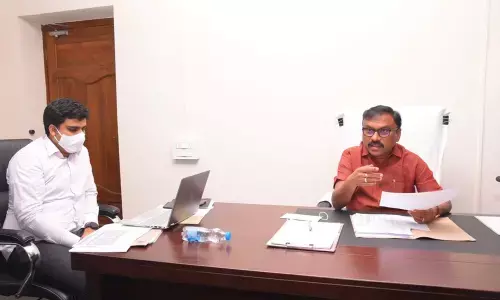 Collector Dr Pola Bhaskara addressing the bank and DRDA officials in the meeting at Ongole on Tuesday