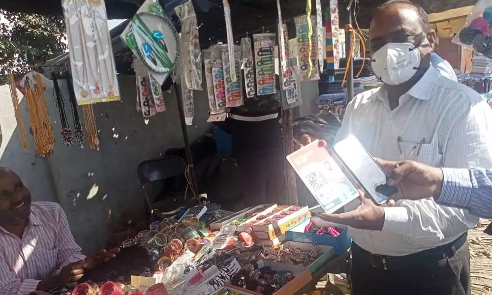 Additional Collector Chandra Reddy checking whether roadside vendors are using digital transaction in Narayanpet on Wednesday