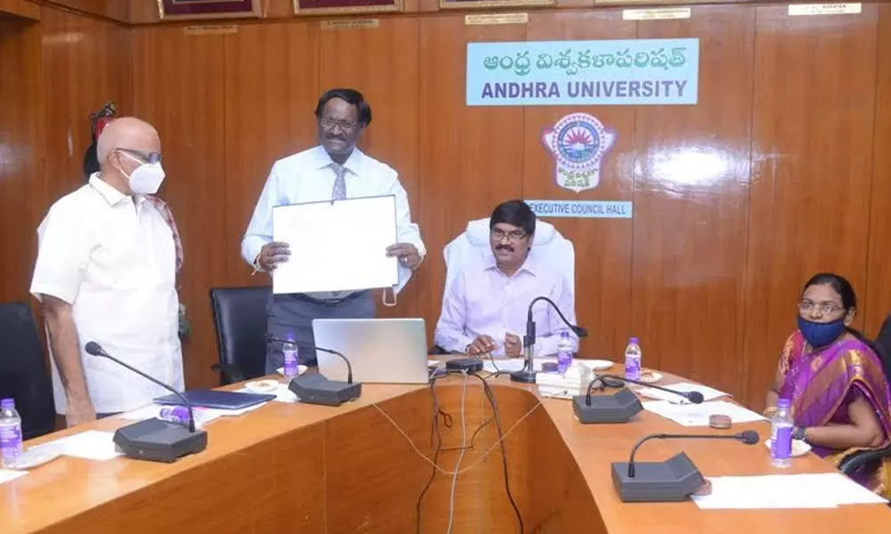 AU Registrar V Krishna Mohan showing the copies of MoU signed by AU and INCOIS at the varsity in Visakhapatnam on Thursday