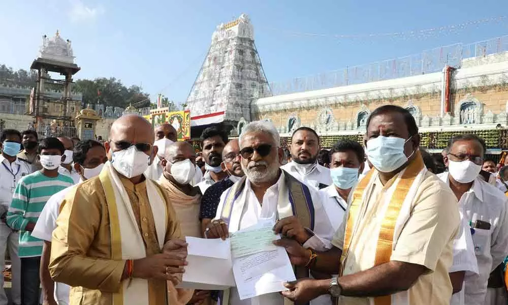 TTD Trust Board member and MLA Kumaraguru handing over the DD for Rs 1 crore as donation for construction of temple in Ulundurpet, Tamil Nadu, to TTD chairman Y V Subba Reddy in Tirumala.
