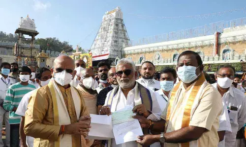 TTD Trust Board member and MLA Kumaraguru handing over the DD for Rs 1 crore as donation for construction of temple in Ulundurpet, Tamil Nadu, to TTD chairman Y V Subba Reddy in Tirumala.