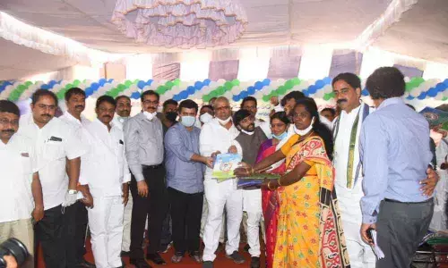 Tourism Minister Muttamsetti Srinivasa Rao distributing house site pattas to the beneficiaries in Visakhapatnam on Friday