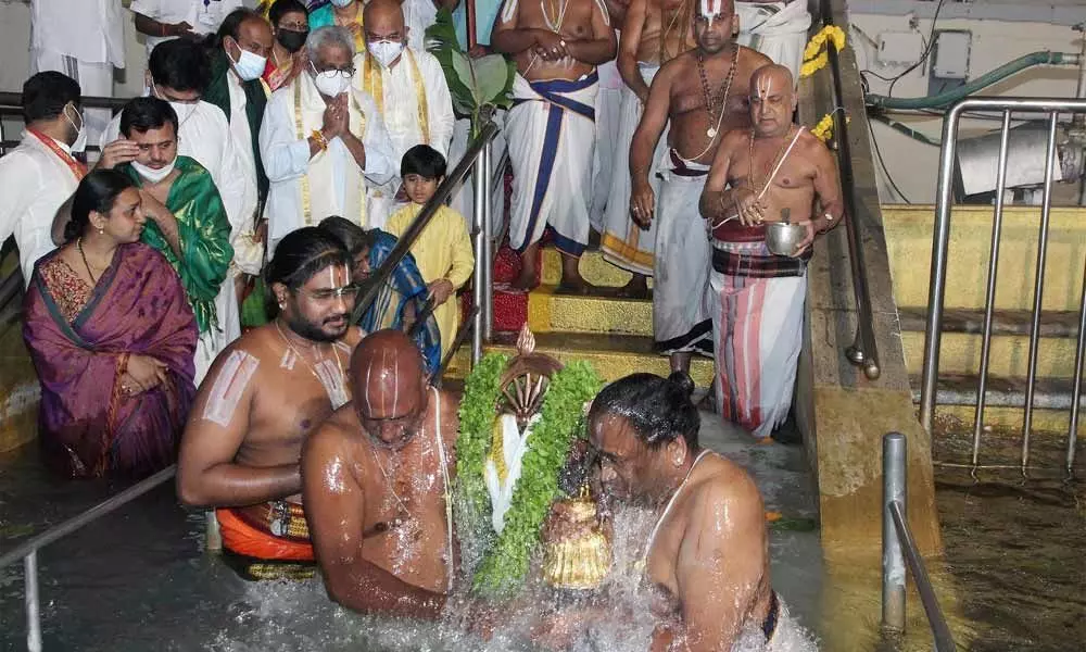 Tirumala temple priests immersing the holy disc Chakrathalwar in the Pushkarini at Tirumala on the occasion of Vaikunta Dwadasi on Saturday