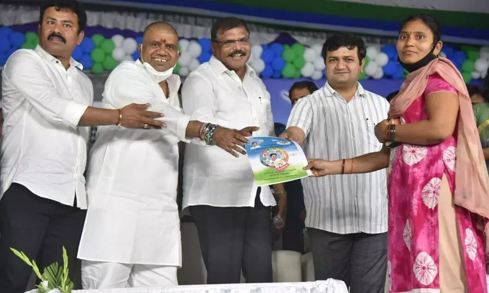Minister for Municipal Administration and Urban Development Botcha Satyanarayana and Tourism Minister M Srinivasa Rao participating in the distribution of house pattas in Visakhapatnam on Sunday.