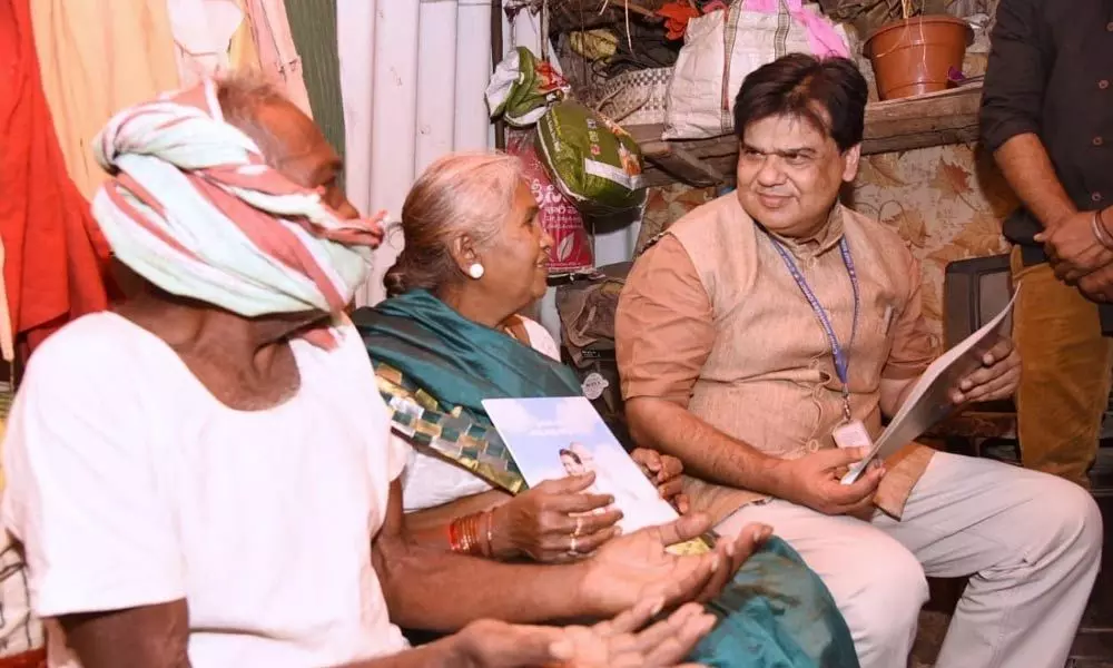 Praveen Prakash with the beneficiaries of housing scheme
