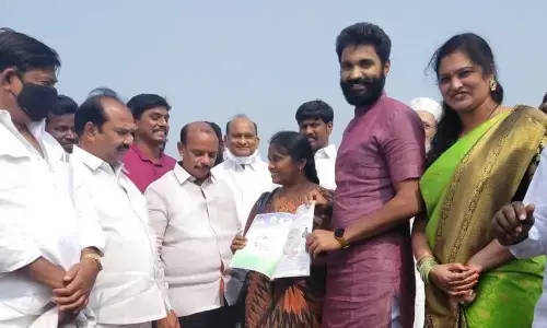 MP Margani Bharat and YSRCP city coordinator Srighakollapu Sivarama Subramanyam distributing house site pattas at Velugubanda village on Sunday