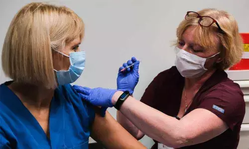 Krystyna Matusik, a nurse from the Krakow University Hospital Intensive Care Unit, is given the first jab of the Pfizer-BioNTech Covid-19 vaccine in Krakow, Poland on Sunday