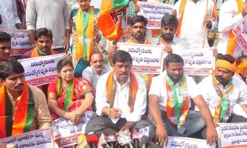 BJP district chief Galla Satyanarayana speaking to the media during rasta roko in Khammam on Tuesday