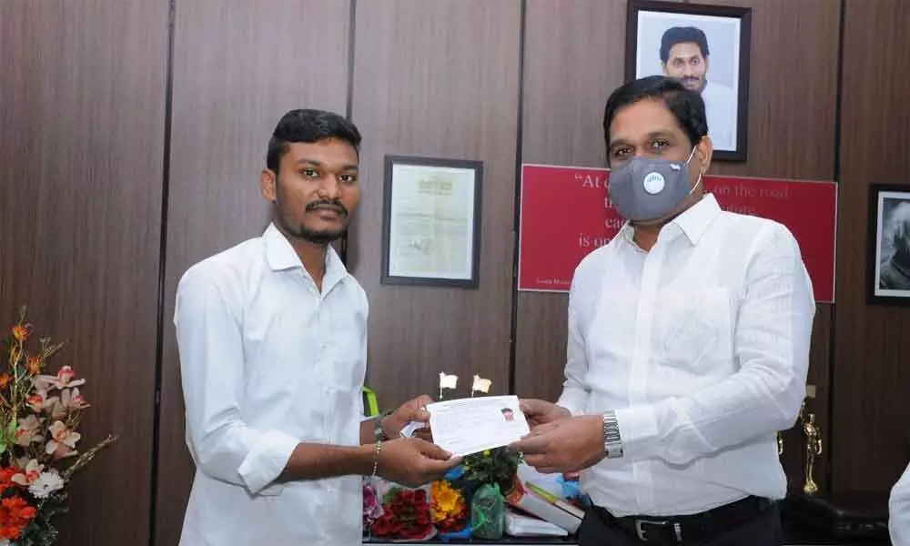 APSRTC managing director and vice-chairman M T Krishna Babu handing over complimentary bus pass to outsourcing employees in Vijayawada on Friday