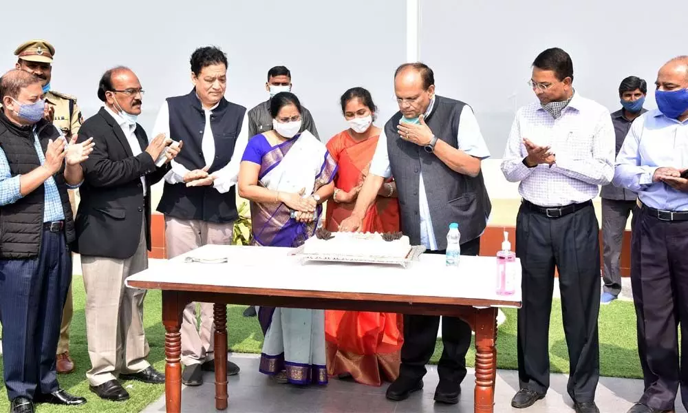 Chief Secretary Somesh Kumar cutting a cake as part of New Year celebrations at BRKR Bhavan in Hyderabad on Saturday