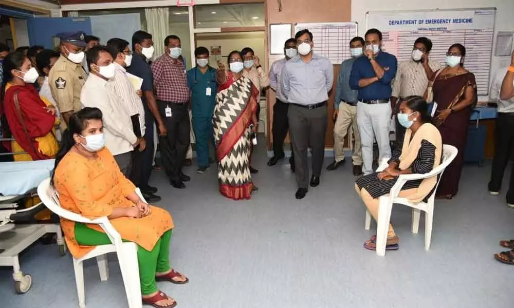 District Collector K V N Chakradhar Babu interacting with the staff members at the dry run session site in Narayana General Hospital in Nellore on Saturday