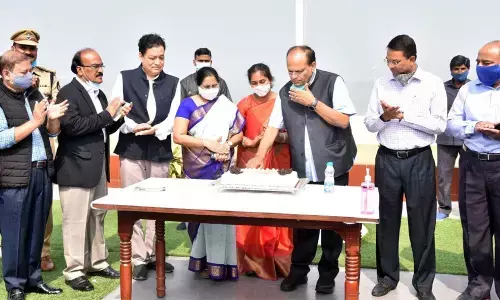 Chief Secretary Somesh Kumar cutting a cake as part of New Year celebrations at BRKR Bhavan in Hyderabad on Saturday