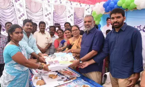 Chandragiri MLA Chevireddy Bhaskar Reddy distributing house site patta to a woman beneficiary at Upparapalli in Pakala mandal in Chandragiri constituency on Sunday