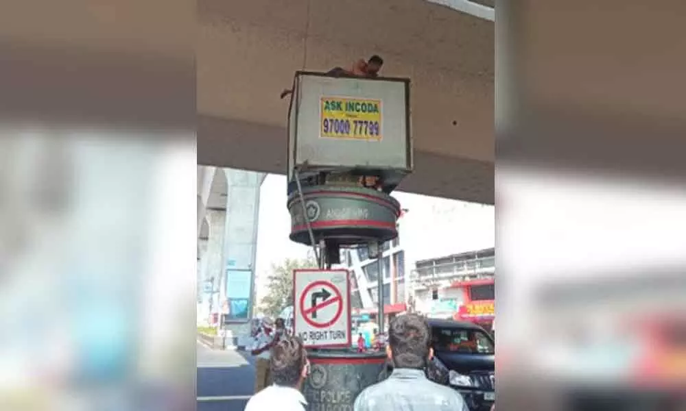 Mentally ill man tries to kill self by jumping off traffic post in Punjagutta