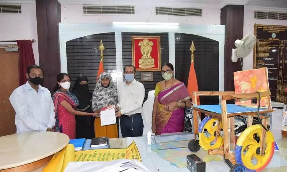 District Collector Prashant Jeevan Patil receiving 2 BHK application from a student Basheera and her mother Intiaz at his chamber at Nalgonda Collectorate