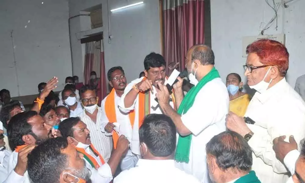 BJP leaders arguing with district Rythu Bandhu Samanvaya Committee members during at a meeting