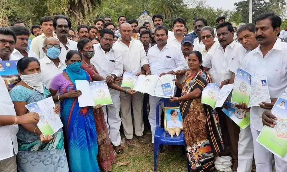 Jaggampeta MLA Jyothula Chanti Babu distributing house site pattas at Tantikonda villlage on Wednesday