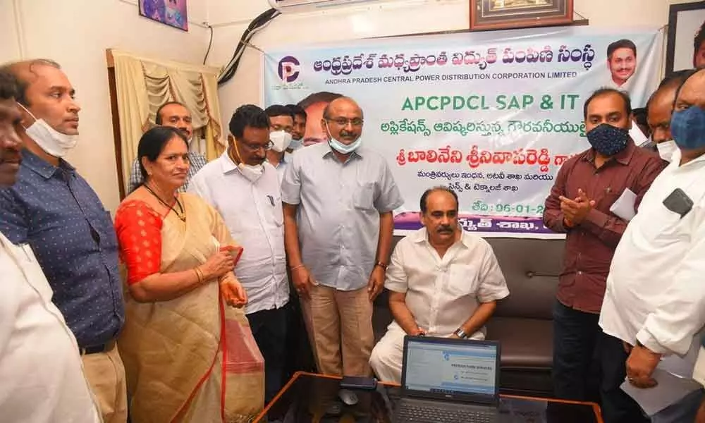 Minister Balineni Srinivasa Reddy interacting with the APSPDCL officials after inaugurating the SAP & IT services in Ongole on Wednesday