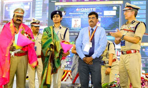 DGP D Gautam Sawang felicitating father-daughter duo - Circle Inspector Shyam Sundar and DSP Jessy Prashanti - at the State Police Duty Meet in Tirupati on Wednesday