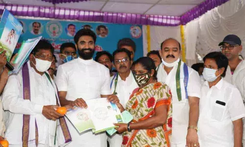 MP Margani Bharat Ram distributing house site pattas to the beneficiaries at Jegurupadu village on Wednesday